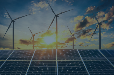 Solar panels are shown with wind turbines in the distant background
